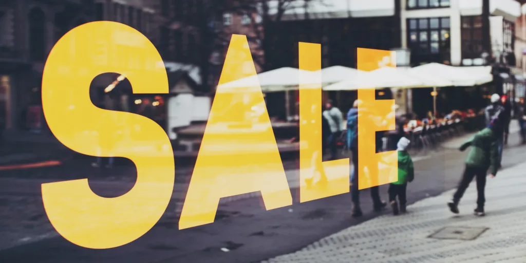 A storefront with a large sale sign on the window, promoting discounts and special offers. Digital marketing in times of recession